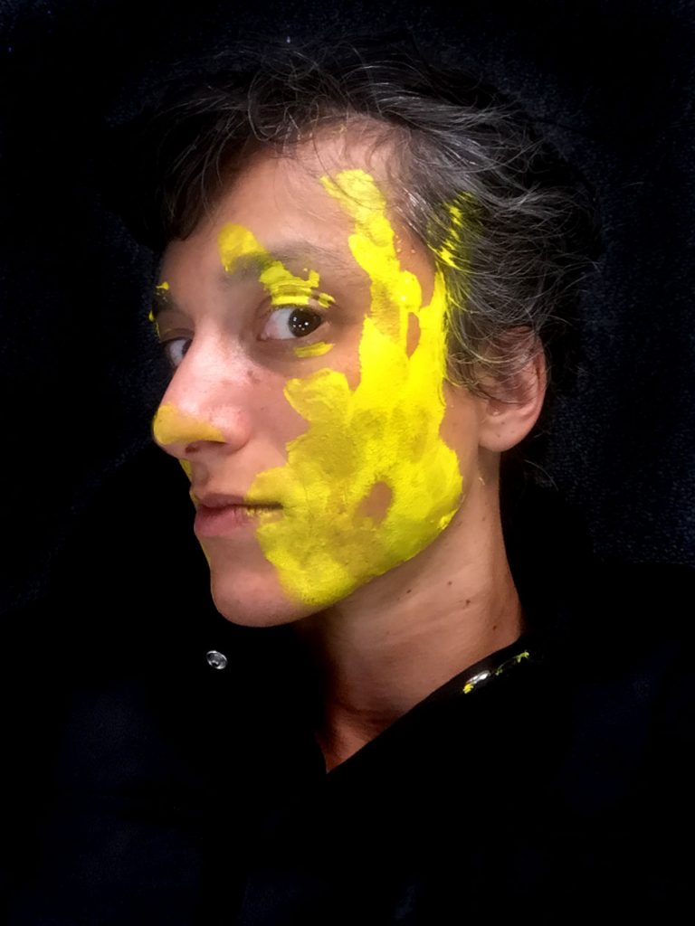 Portrait of Cristina Reyes with yellow paint