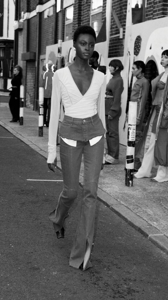 Alisha walking in the performance artwork / runway fashion show for Miista AW2022. Art by Cristina Reyes. Vyner Street.